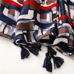 Detailed macro shot of cotton-linen feel scarf with geometric patterns and fringe