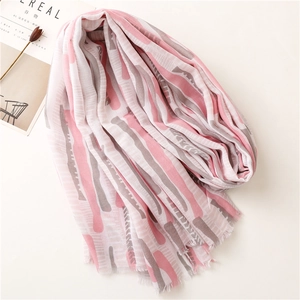 Detail of pink and grey geometric print scarf with soft frayed edges on cotton fabric