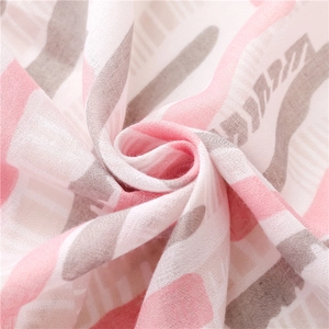 Macro detail of breathable pink and grey gauze fabric showing soft woven texture