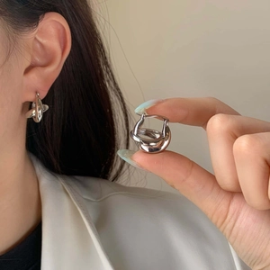 Boucles d'oreilles créoles torsadées en argent au design minimaliste avec éclat métallique