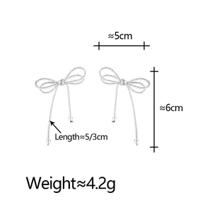 Silver crystal bow tassel earrings with white pearls featuring elegant hanging beads