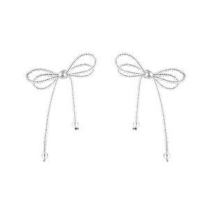 White crystal bow tassel earrings with a centered pearl in a minimalist elegant design