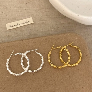 Fashion large hoop earrings set in gold and silver finish with textured bead design