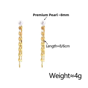 Detail view of long gold tassel earrings with 8mm pearls and fine metal chains