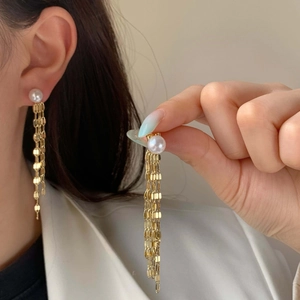 Elegant gold tassel earrings with round white pearl and long metal fringe for women