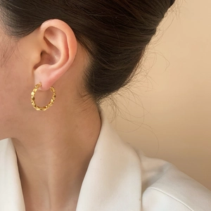 Textured gold hoop earrings for women featuring a minimalist bold circular design