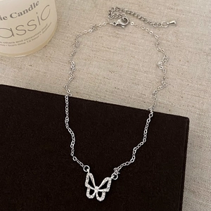 Detail of silver hollow butterfly pendant necklace with sparkling cubic zirconia stones