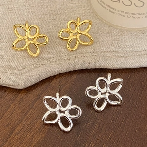 Minimalist hollow flower stud earrings set in gold and silver finish for women