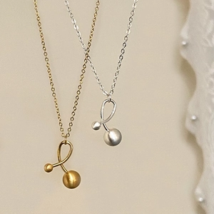Minimalist gold and silver necklaces with abstract curved metal pendants and matte beads