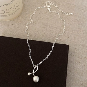 Detail of silver chain with irregular double ball geometric pendant and matte finish
