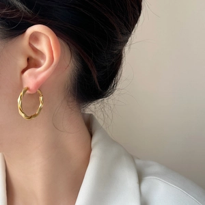Minimalist matte gold twisted hoop earrings featuring a stylish Möbius design for women