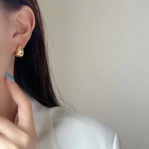 Minimalist gold teardrop hoop earrings with micro-set zircon on model
