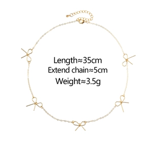 Elegant gold bow necklace featuring five delicate butterfly pendants and adjustable chain