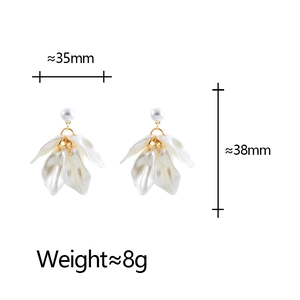Detail view of flower petal tassel earrings with acrylic petals and pearl studs