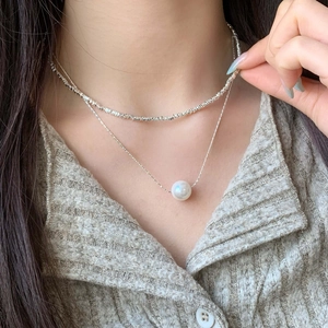 Double-layer silver necklace with irregular metal beads and a round white pearl pendant