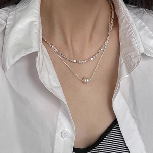 Elegant double layer silver necklace featuring a pearl pendant and crushed silver beads