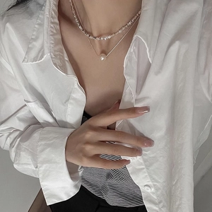 Double-layer silver necklace featuring irregular metal beads and a white pearl pendant