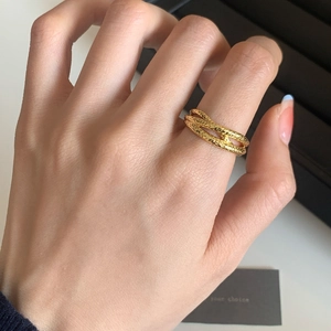 Elegant gold-tone multi-layer intertwined ring with a textured hammered finish on hand