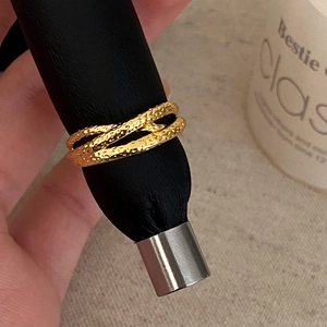 Detailed shot of gold-plated multi-layer crossover ring with hammered rock texture