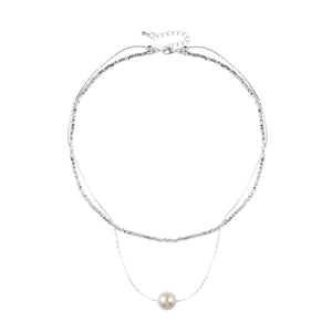 Double layered silver necklace featuring a minimalist round pearl pendant on a white background