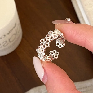 Elegant adjustable silver hollow floral ring featuring continuous 5-petal flower design