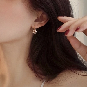 Elegant rose gold flower earrings with pearls shown on model for a graceful daily look