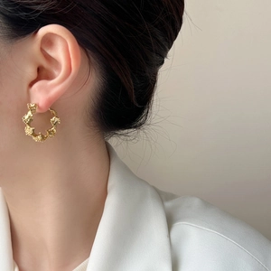 Chic gold irregular lava texture hoop earrings shown worn on ear for minimalist style