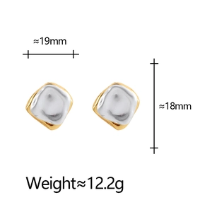 Detailed view of irregular gold and silver contrast earrings with lava texture and dimensions