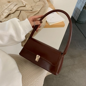 Classic dark brown glossy leather baguette bag with gold buckle and retro shoulder strap