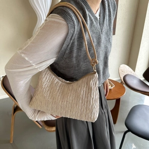 Cream pleated hobo shoulder bag with wavy texture for casual daily commuting style