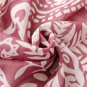 Detailed macro shot of red and white paisley pattern on breathable cotton linen fabric