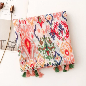 Close-up of bohemian geometric print scarf with colorful tassels and soft cotton-linen texture