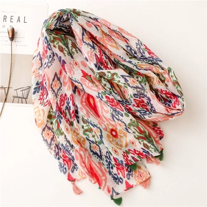Colorful geometric print scarf with fringes on white background with dried flower decoration