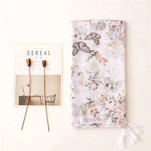 Lightweight white scarf with pink floral and butterfly prints and tassel trim for women