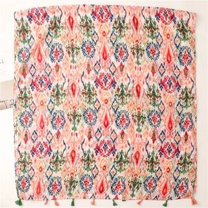 Ethnic style ikat print scarf with colorful geometric patterns and decorative tassels