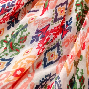 Detailed macro view of colorful geometric boho patterns on soft cotton-linen scarf fabric