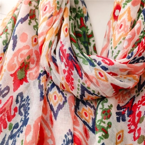 Close-up of geometric patterned cotton scarf with vibrant ethnic print and soft fiber texture
