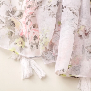 Detail of floral chiffon scarf with sequins and white tassel fringe edges