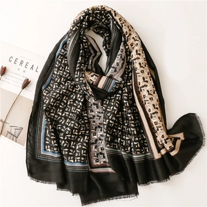 Elegant black cotton linen scarf with gold foil paisley patterns and fringe edges