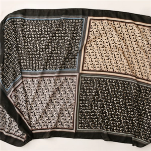 Detail of soft cotton linen scarf featuring a four-panel geometric leaf pattern and tassels