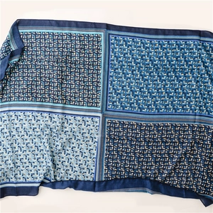 Detail of four-panel blue floral patchwork scarf with delicate fringe and cotton-linen texture