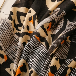 Close-up of leopard and plaid print scarf with premium linen-touch fabric texture