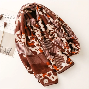 Detail of cotton-linen feel scarf featuring leopard print and geometric patterns