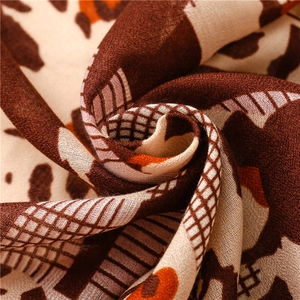 Macro detail of breathable leopard and geometric print fabric on cotton linen scarf