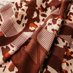 Detailed view of the leopard print cotton linen texture fabric with soft drapes and warm tones
