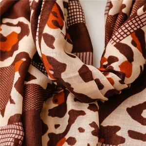 Detailed view of leopard print cotton-linen scarf with brown and orange textures