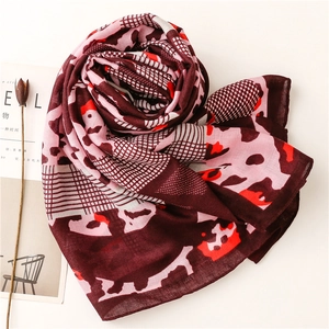 Detail of burgundy leopard and geometric patterns on soft linen-feel scarf wrap