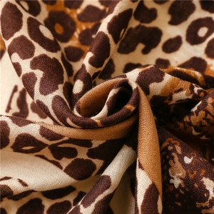 Macro shot of detailed leopard print fabric texture on soft cotton linen scarf