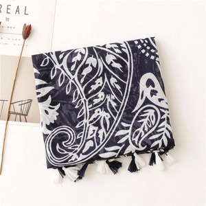 Detailed shot of dark blue paisley scarf featuring delicate fringes and cotton linen texture