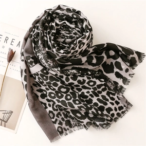 Detail of grey leopard print cotton linen scarf with soft fringe edges and fabric texture